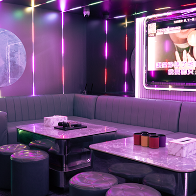 Private KTV room with neon lighting and booth seating